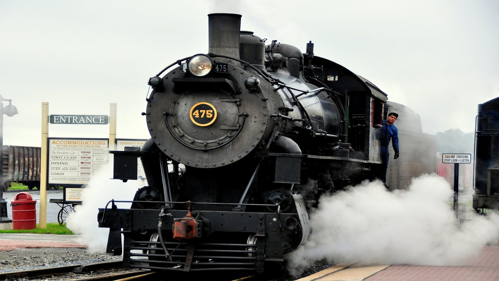 Strasburg, Pennsylvania:  A vintage steam locomotive with its engineer pulling into the Strasburg Railroad station - Xu Lei Photo