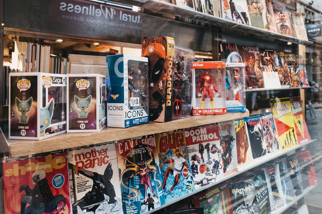 London, UK - December 18, 2018: Comic books on a window retail display of Gosh! Comics shop in Covent Garden a famous tourist area in London with lots of shops and restaurants.