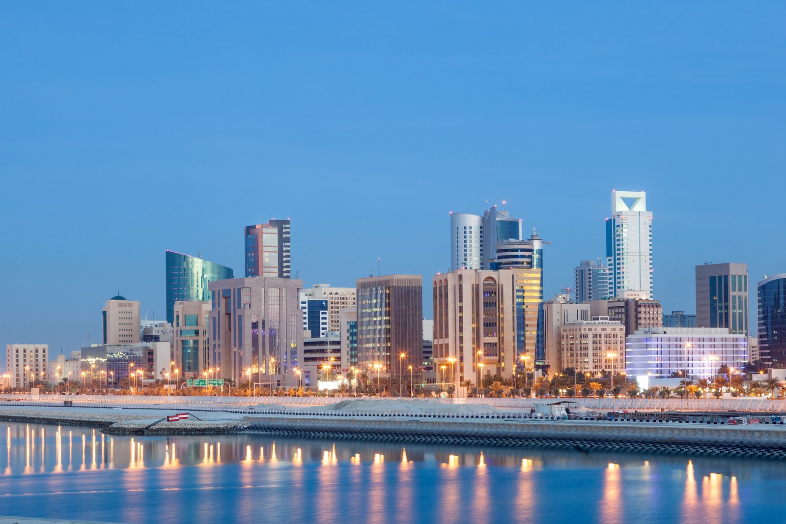 Skyline of Manama city illuminated at night. Kingdom of Bahrain, Middle East