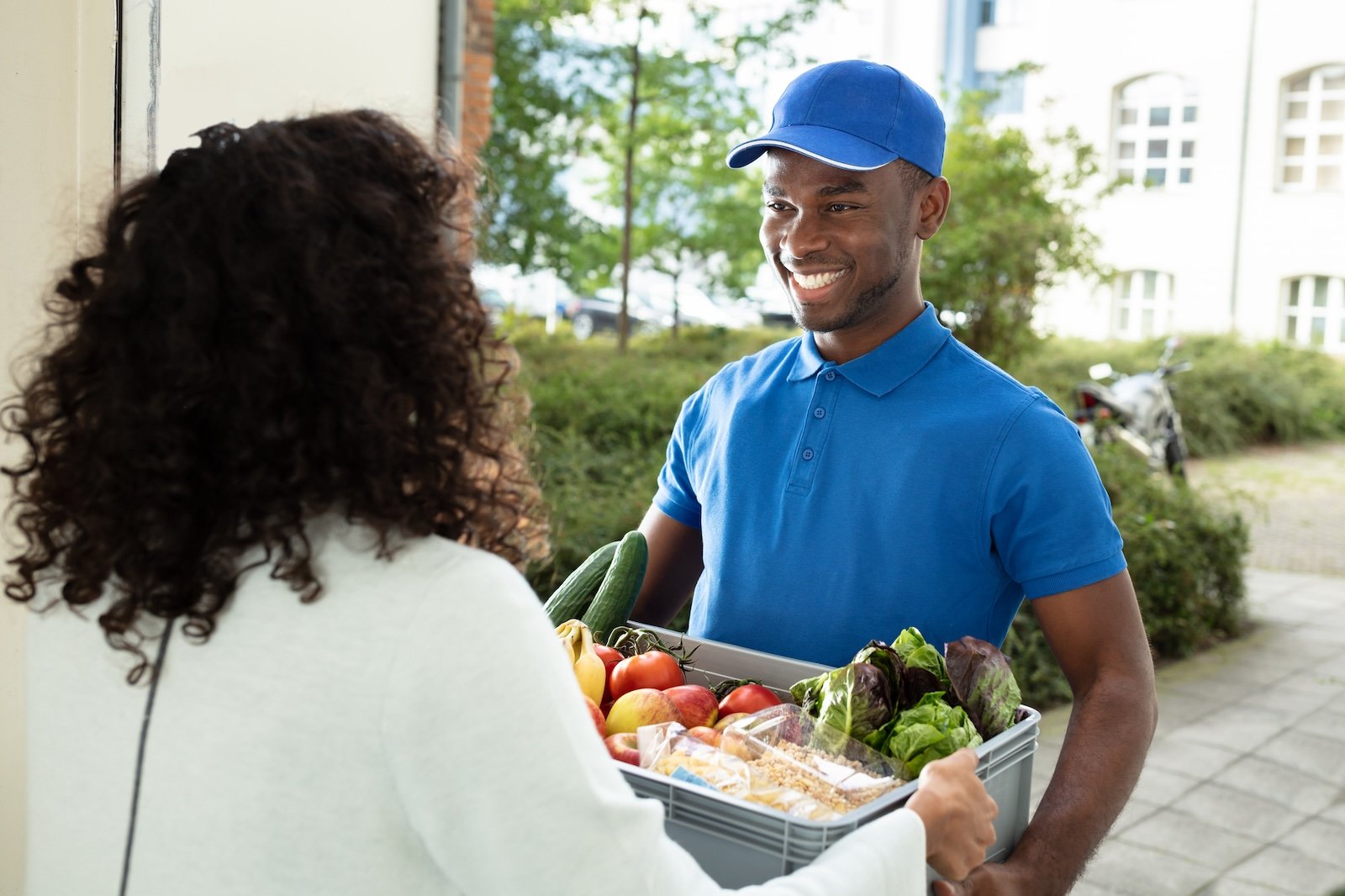Smiling Woman Receiving Grocery Delivery At Home