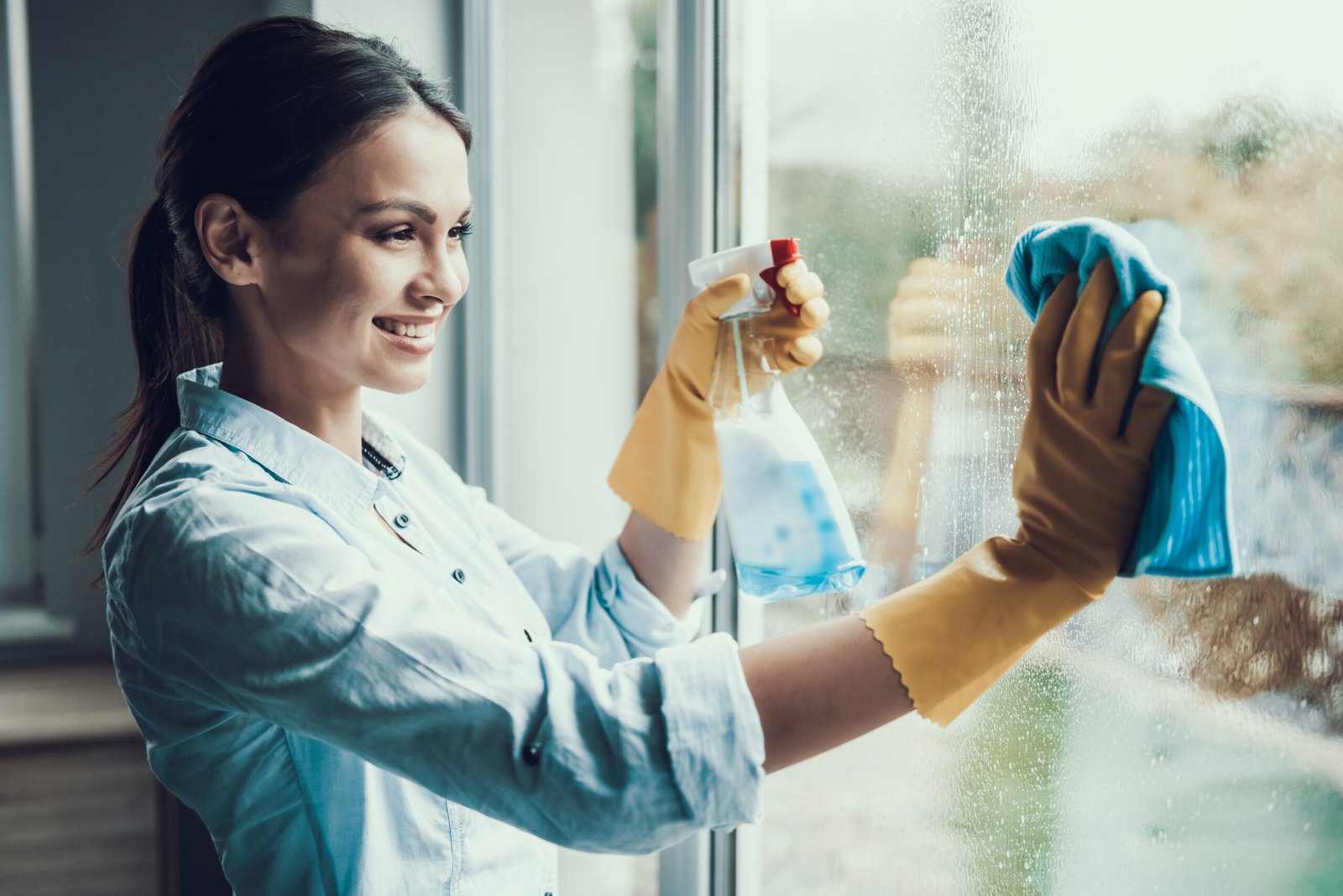 Young,Smiling,Woman,Washing,Window,With,Sponge.,Happy,Beautiful,Girl